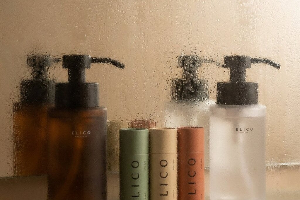 Amber and frosted dispenser on a glass shelf in the bathroom