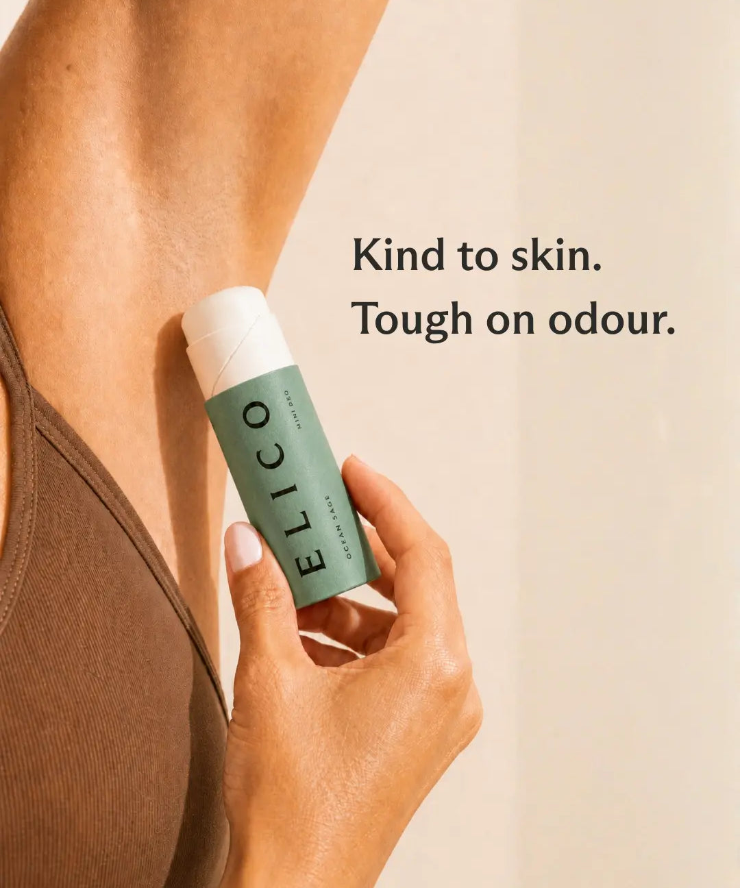 Hand holding an opened Mini Deo Ocean & Sage up to the underarm